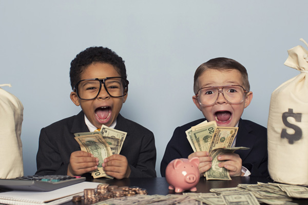two young boys laughing with bags of money